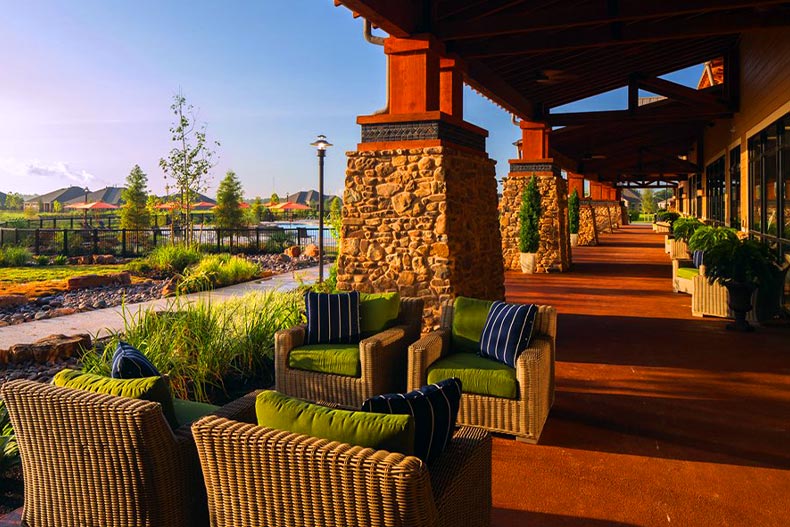 Four chairs on a back patio of The Lakehouse clubhouse in Del Webb Sweetgrass, located in Richmond, Texas