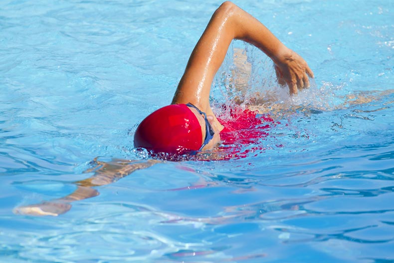 An older woman swimming in a pool