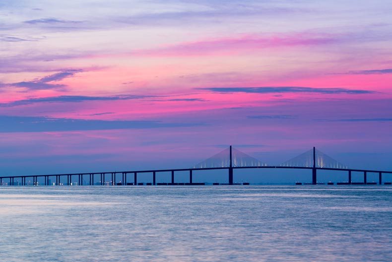 A sunrise behind Sunshine Skyway Bridge from St. Petersburg, Florida across Tampa Bay