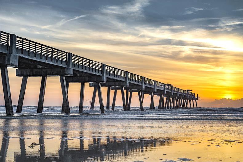 A sunset view of a pier extending into the ocean in Tampa, Florida