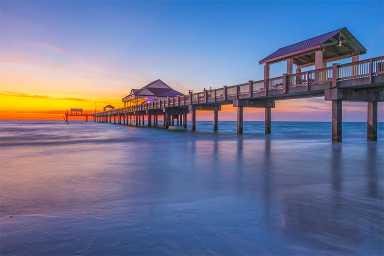 View of a pier in Tampa, Florida backed by an ocean sunset