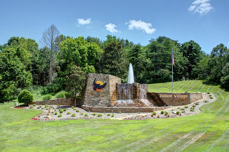 The water feature and greenery surrounding the community sign for Tellico Village in Loudon, Tennessee