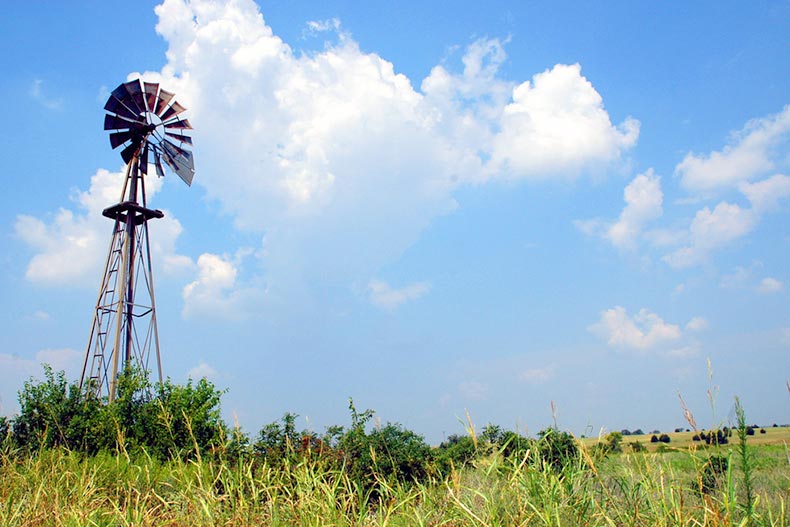 An old windmill in a farm field in Texas
