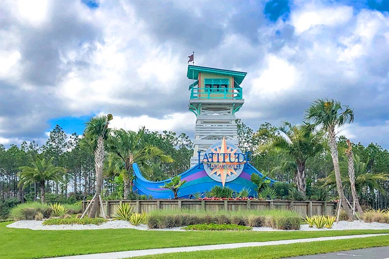 Palm trees surrounding the community sign for Latitude Margaritaville in Daytona Beach, Florida