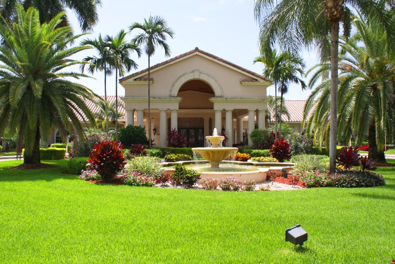 Palm trees and greenery surrounding the clubhouse at The Cascades in Boynton Beach, Florida