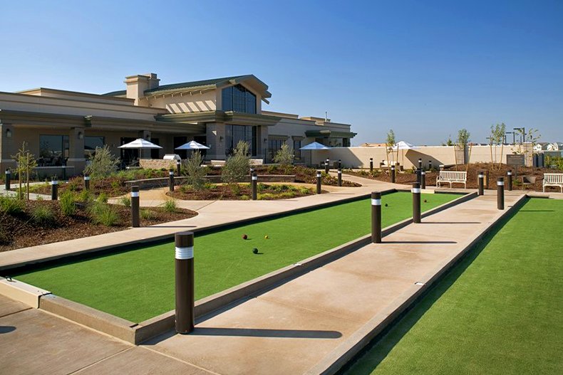 View of two bocce ball courts in front of a clubhouses in The Club at WestPark, located in Roseville, California