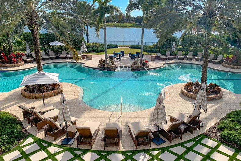 Lounge chairs beside the outdoor pool at The Lake Club at Lakewood Ranch in Lakewood Ranch, Florida
