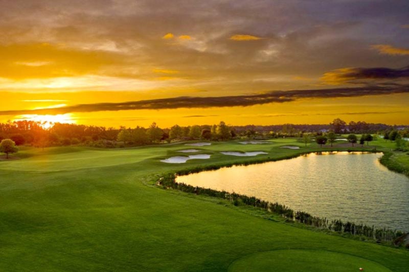 View of the sunset over the golf course The Lakes at Harmony.
