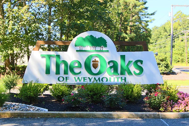 Greenery surrounding the community sign for The Oaks of Weymouth in Mays Landing, New Jersey