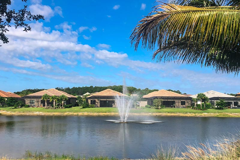 View of the pond at The Plantation with single-family homes in the background.