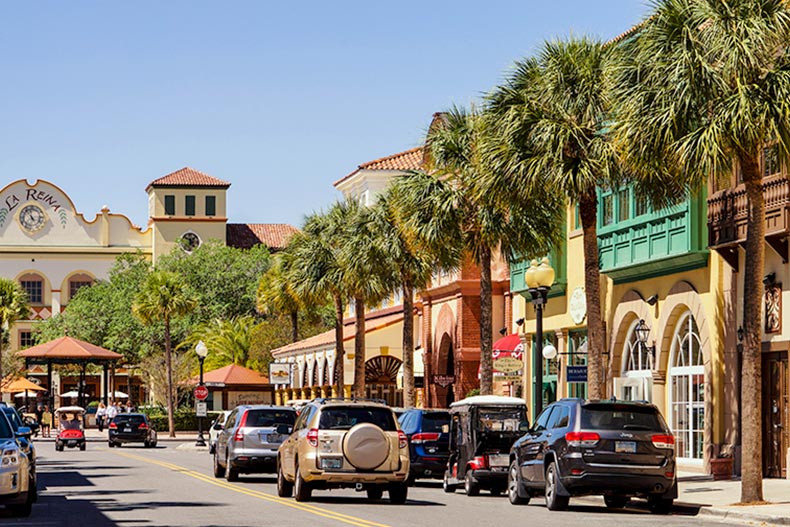 Shops and palm trees lining a street in The Villages in Florida