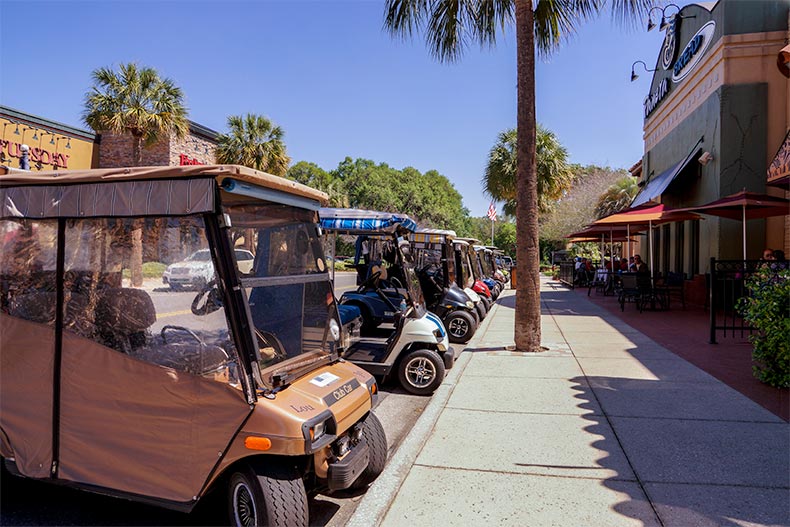 Golf carts lined up along the street in The Villages, Florida