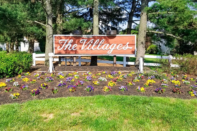 Flowers surrounding the community sign for The Villages in Howell, New Jersey