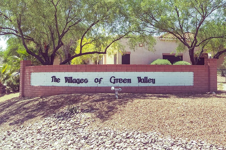 Trees behind the community sign for The Villages of Green Valley in Green Valley, Arizona