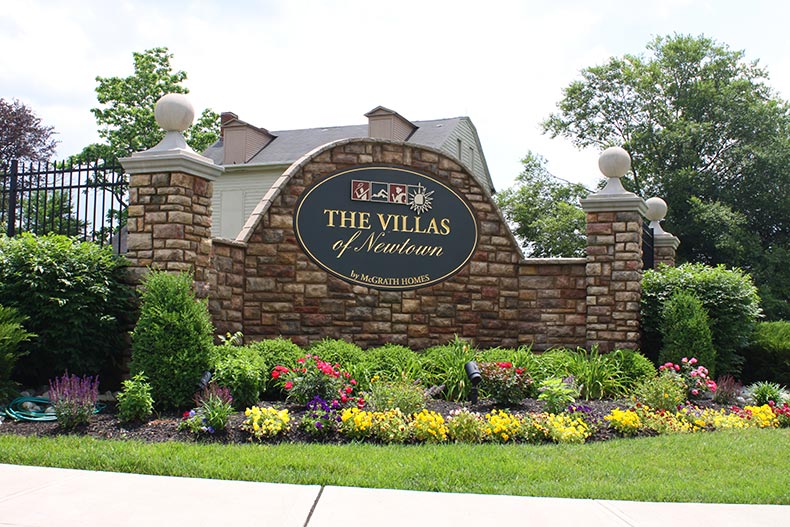 Greenery surrounding the community sign for The Villas of Newtown in Newtown, Pennsylvania