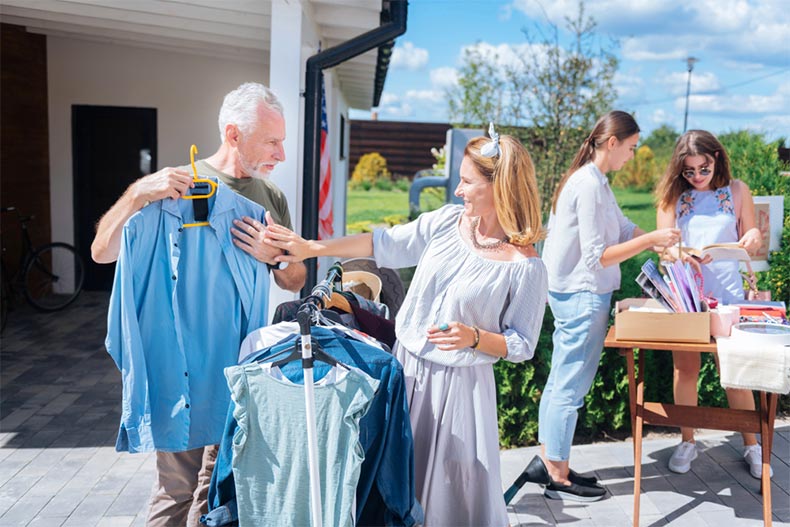 An active adult couple shopping at a yard sale