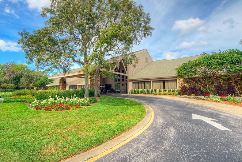 Trees and greenery outside the entrance to the clubhouse at Timber Pines in Spring Hill, Florida