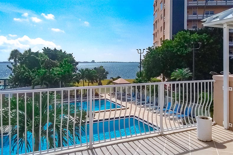 A balcony overlooking the outdoor pool at Town Shores of Gulfport in Gulfport, Florida