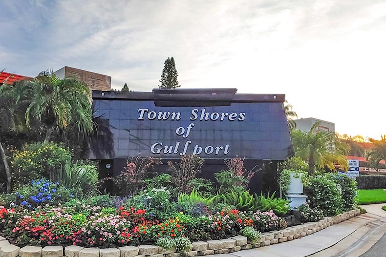 Flowers and greenery surrounding the community sign for Town Shores of Gulfport in Gulfport, Florida