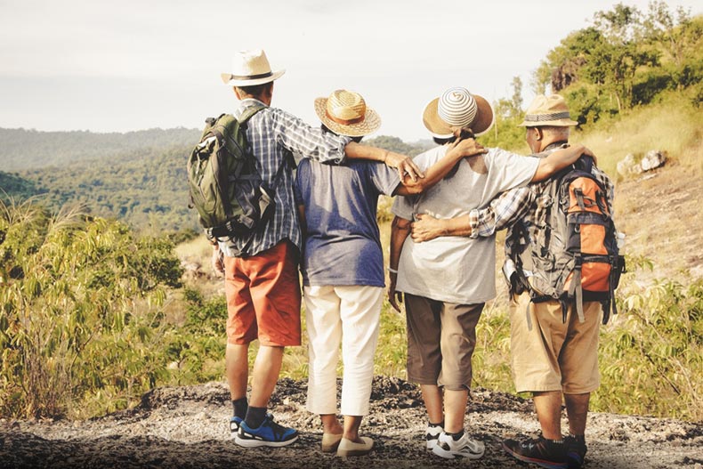 A group of seniors with their arms around each other on a volunteer trip