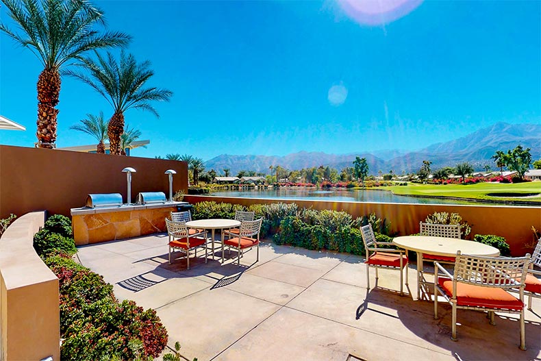 A pond and palm tress beside the outdoor patio at Trilogy at La Quinta in La Quinta, California