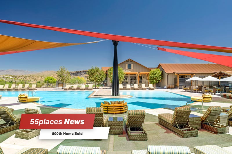 "800th Home Sold" banner over lounge chairs on the patio surrounding the outdoor pool at Trilogy at Wickenburg Ranch in Wickenburg, Arizona