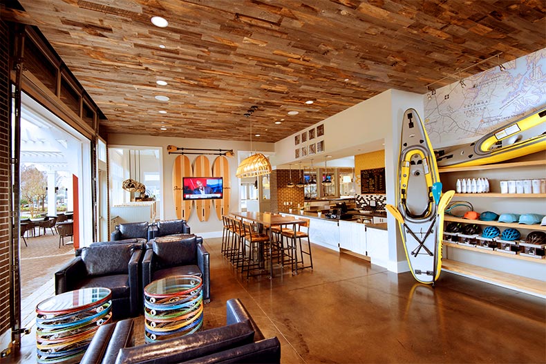 Interior view of a clubhouse with seating, watersport gear, and a kitchen, located in Trinity Lake Norman of Denver, North Carolina