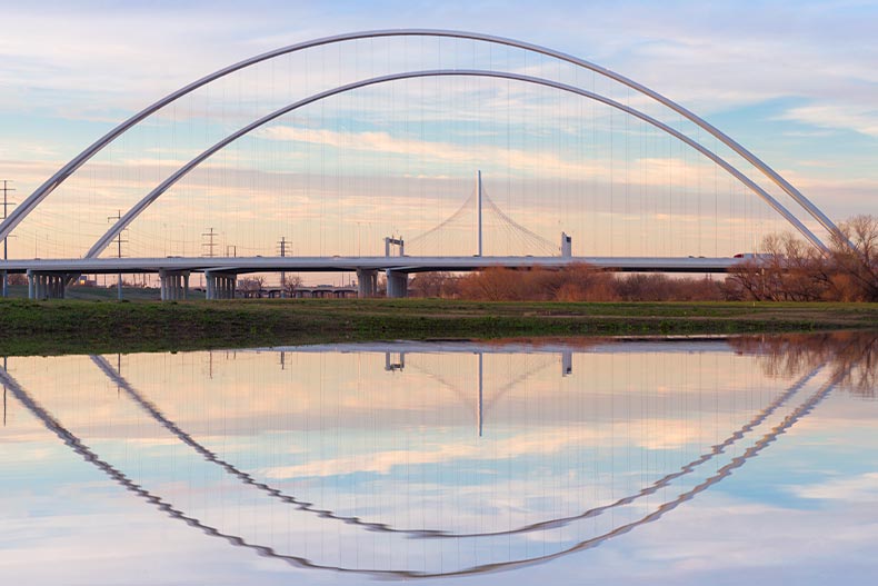 Photo of the Margaret Hunt Hill Bridge and Margaret McDermott Bridge reflection in the Trinity River in Dallas, Texas