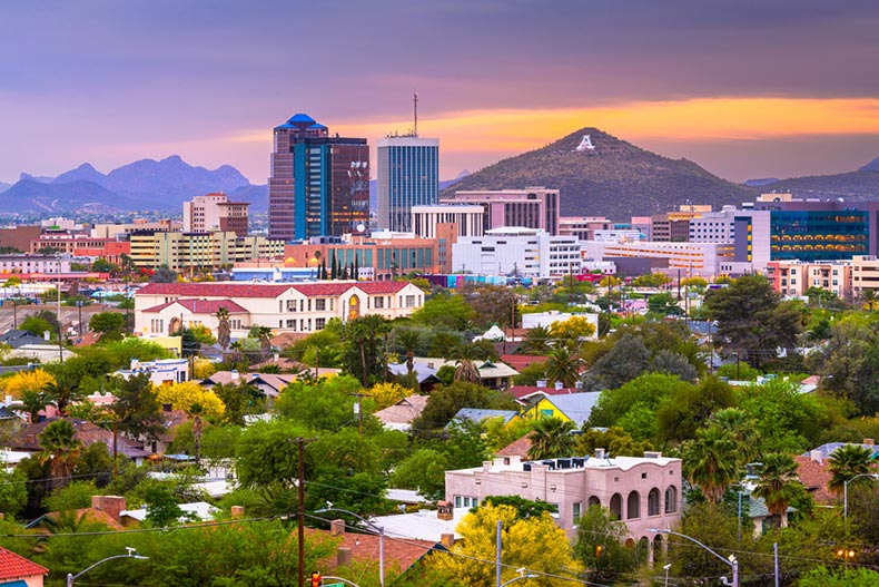 Twilight view of the downtown city skyline of Tucson, Arizona with mountains in the background