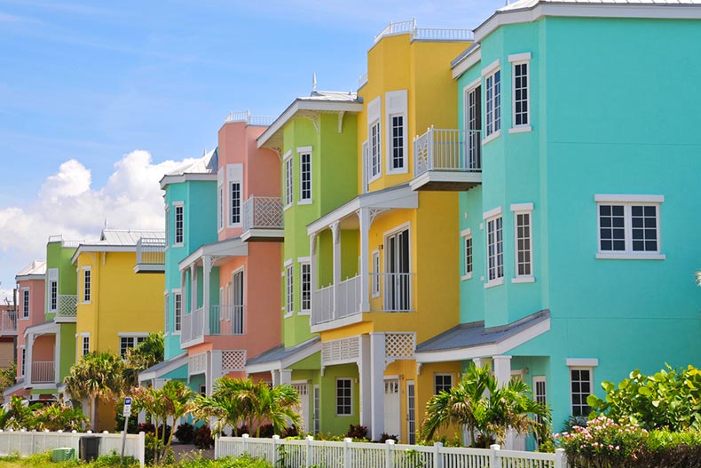 Palm trees beside colorful beach condos for rent