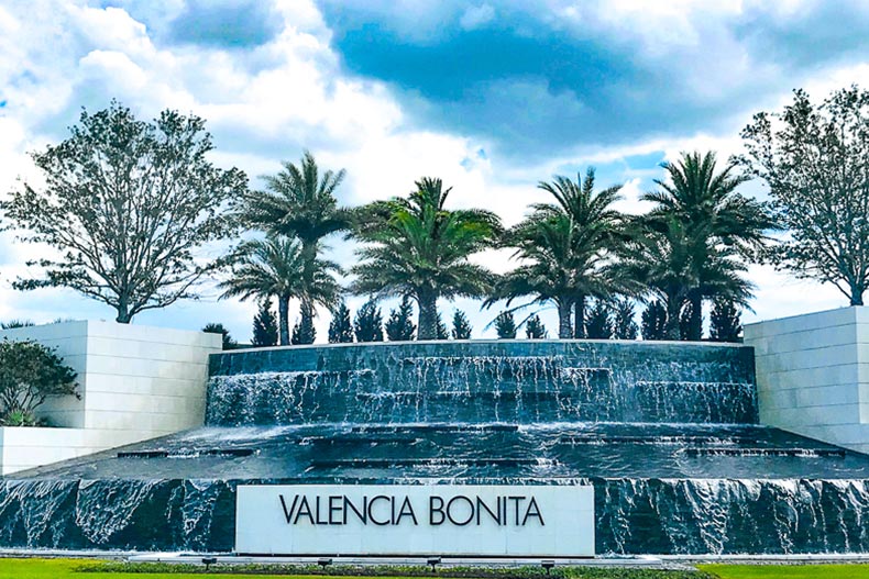 Trees surrounding a fountain and the community sign for Valencia Bonita in Bonita Springs, Florida
