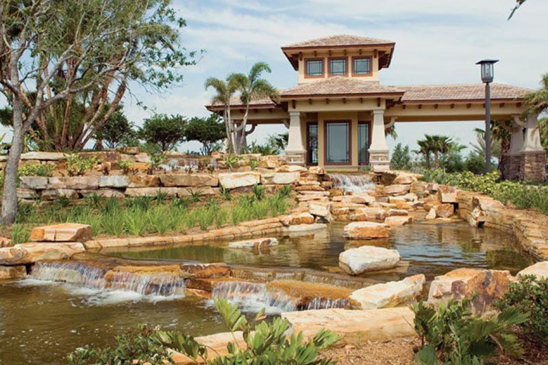 Landscaping at Valencia Lakes in Wimauma, FL with rocks and a rolling stream.