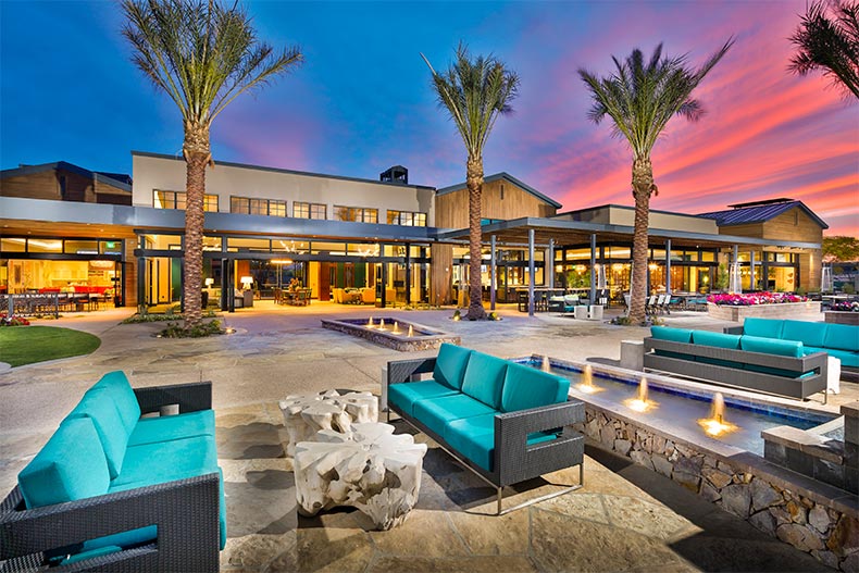 Outdoor seating near modern clubhouse during scenic sunset in Trilogy at Verde River, AZ