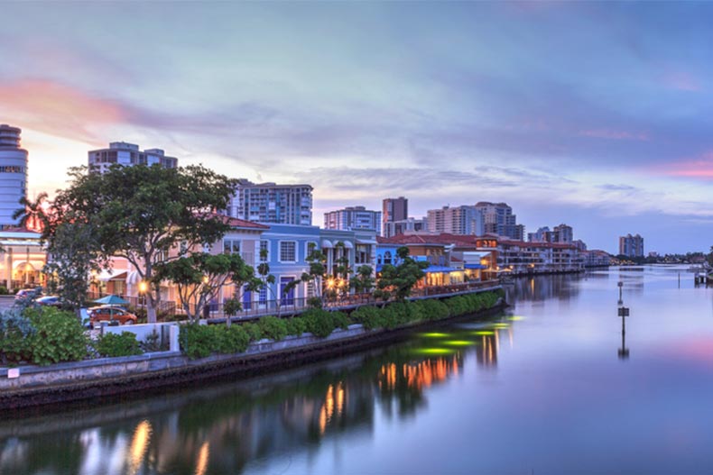 Sunset view of the colorful shops of the Village on Venetian Bay in Naples, Florida