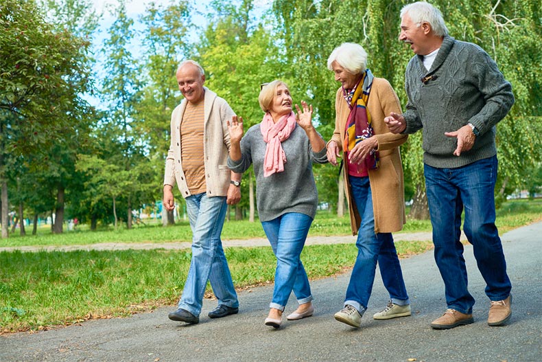 Older friends walking together in a 5%+ community