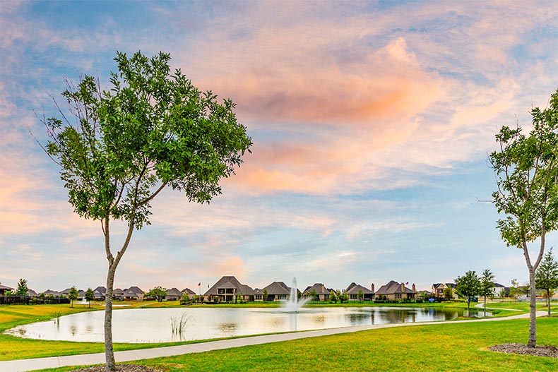 Trees and a pond on the grounds of Waterford Point at The Tribute in The Colony, Texas