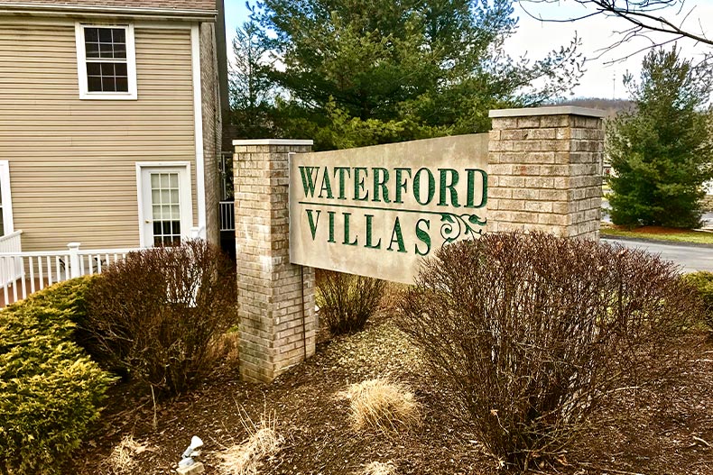 The community sign for Waterford Villas surrounded by naked shrubbery, located in Canonsburg, Pennsylvania