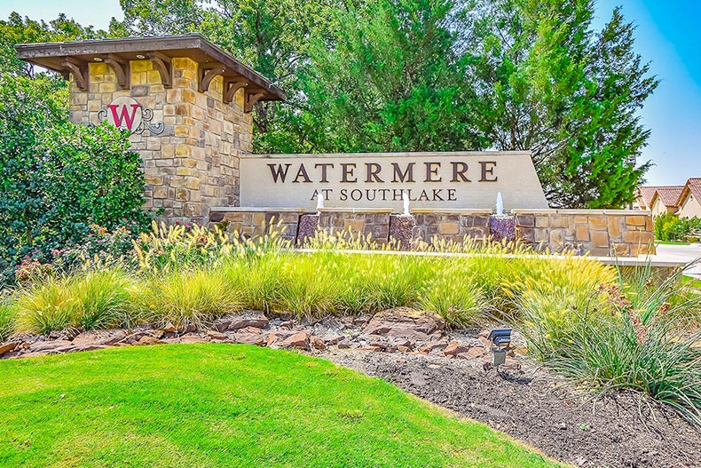 Trees and greenery surrounding the community sign for Watermere at Southlake in Texas