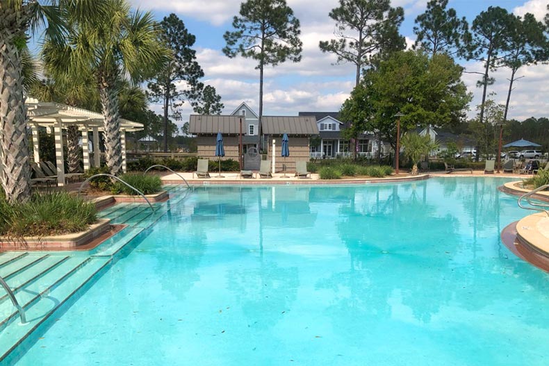 Palm trees surrounding the outdoor pool at Watersound Origins in Watersound, Florida