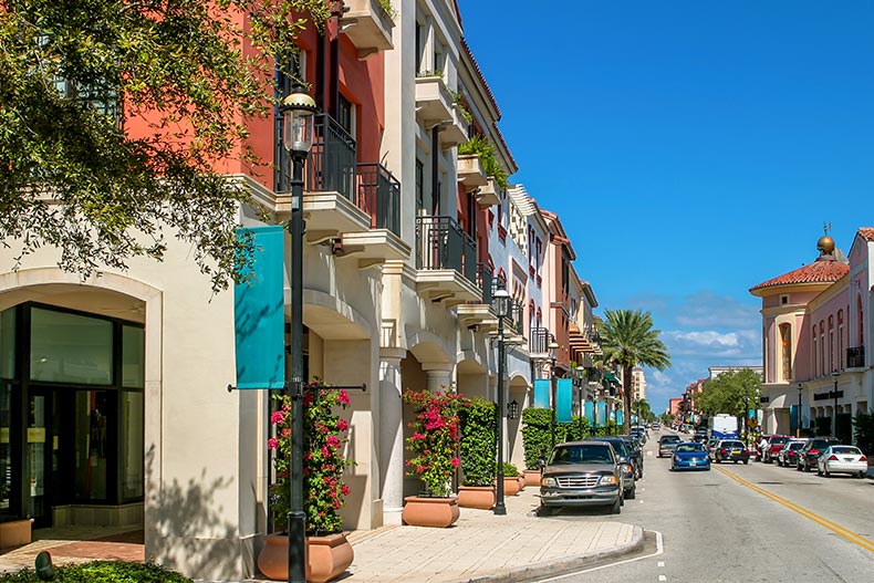 View down a street lined with businesses and apartments in West Palm Beach, Florida