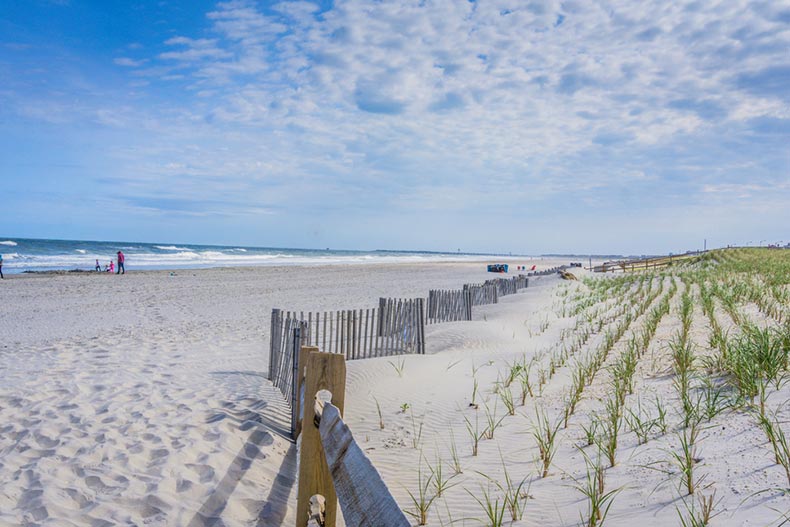 A fence running along the sandy shores of New Jersey