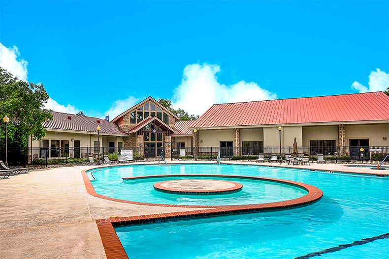 The clubhouse and the outdoor pool at Windsor Lakes in The Woodlands, Texas