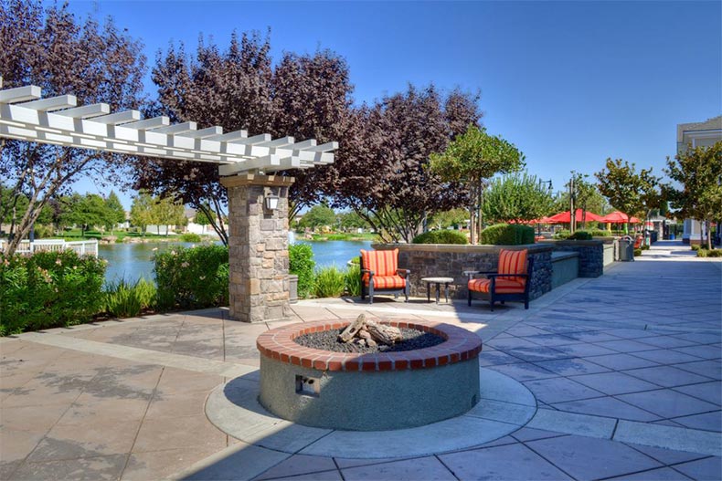 Outdoor lounge chairs beside a fire pit at Woodbridge in Manteca, California