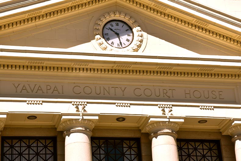 Exterior photo of the Yavapai County Court House in Prescott Arizona cropped to show the engraving and clock